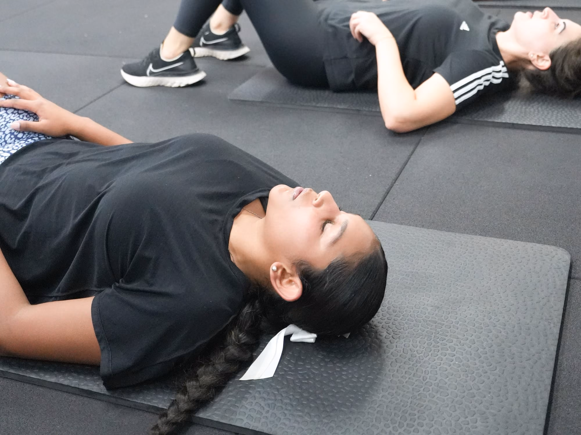 Women lying on mats during a floor class at Sabél Studios